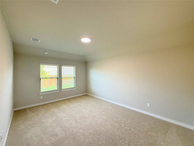 Spare room featuring light carpet and baseboards | Image 13