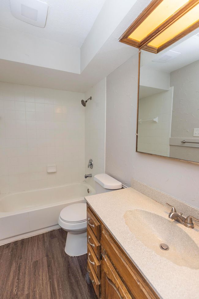 Full bath featuring toilet, wood finished floors, vanity, and shower / washtub combination | Image 20