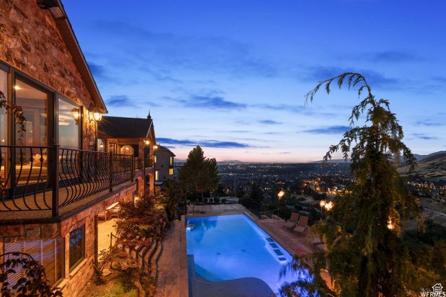 Pool at dusk featuring an outdoor pool and a patio | Image 7