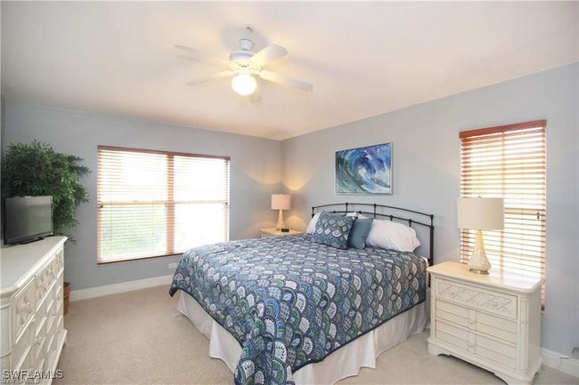 Carpeted bedroom with multiple windows and ceiling fan | Image 12