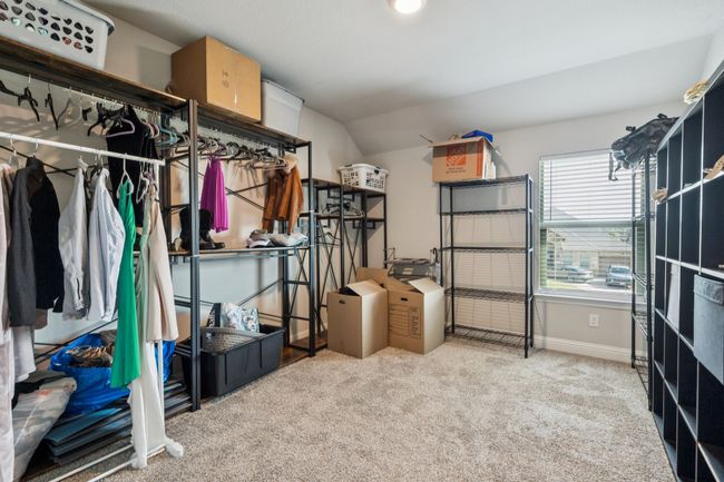 Walk in closet with carpet floors and lofted ceiling | Image 25