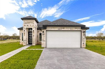 View of front facade featuring a garage and a front lawn | Image 1