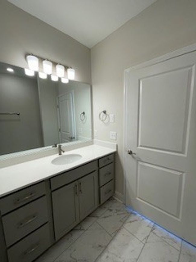 Master bath with tile floor and extended quartz counter | Image 13