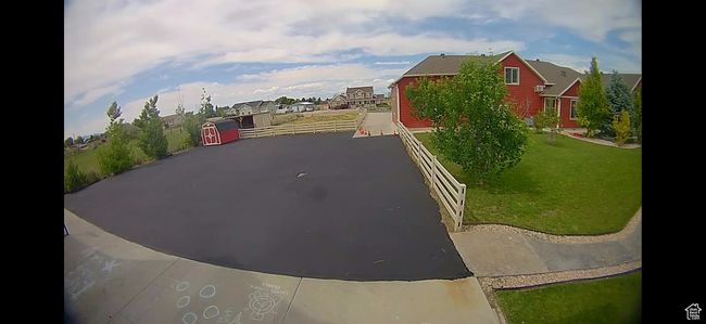 View of back area asphalt driveway featuring a residential view | Image 106