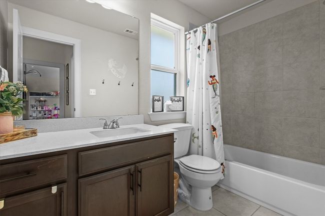Bathroom featuring vanity, tile patterned floors, and shower / bath combo with shower curtain | Image 30