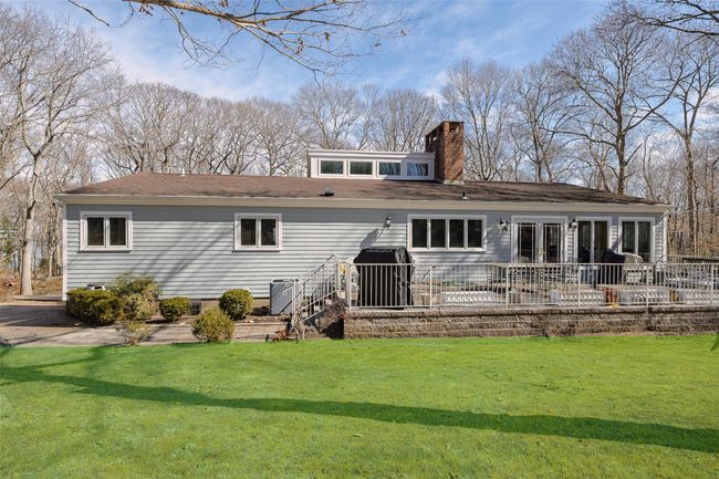 Back of house featuring a yard, a patio area, and a chimney | Image 33