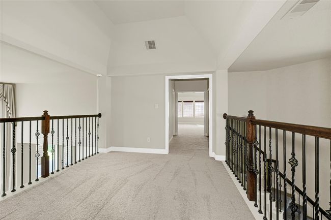 The upstairs landing connects rooms beautifully and gives way to views of both the foyer and the main living area below. | Image 29