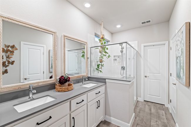 Bathroom with a sink, visible vents, wood finished floors, and a stall shower | Image 18