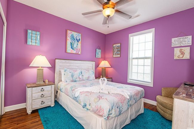 Bedroom featuring dark wood-type flooring, baseboards, and ceiling fan | Image 16