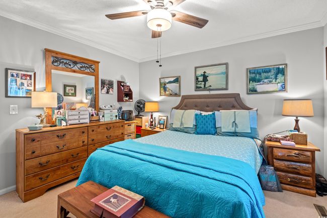 Bedroom featuring carpet floors, crown molding, and ceiling fan | Image 14