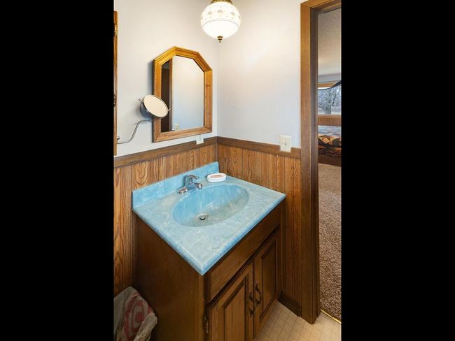 Half bath in the primary bedroom, plus a storage closet behind the sink that offers potential for a future bathroom expansion. | Image 35