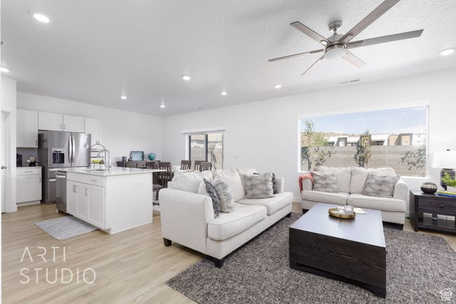 Living area with recessed lighting and light wood-style flooring | Image 9