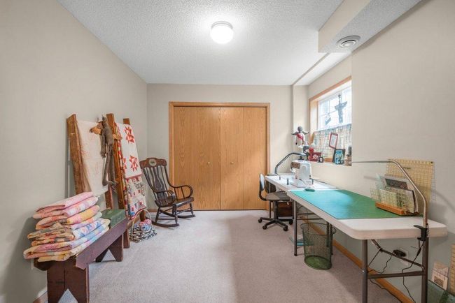 Basement bedroom is bright with french doors, plenty of storage/closet space, and built-ins. | Image 21