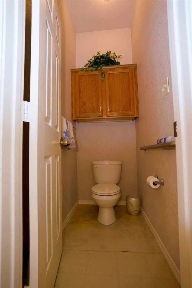 Bathroom with toilet and tile patterned floors | Image 22
