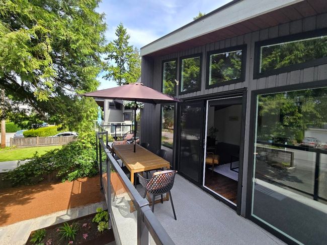 West facing balcony overlooking the breathtaking tree w seating + a wrecking ball for the kids to swing on, a fire table area, garden box, a basketball hoop, & 6 parking incl. a 2 car carport. B.G School is at end of the block! The ocean is 4 blocks away! | Image 13