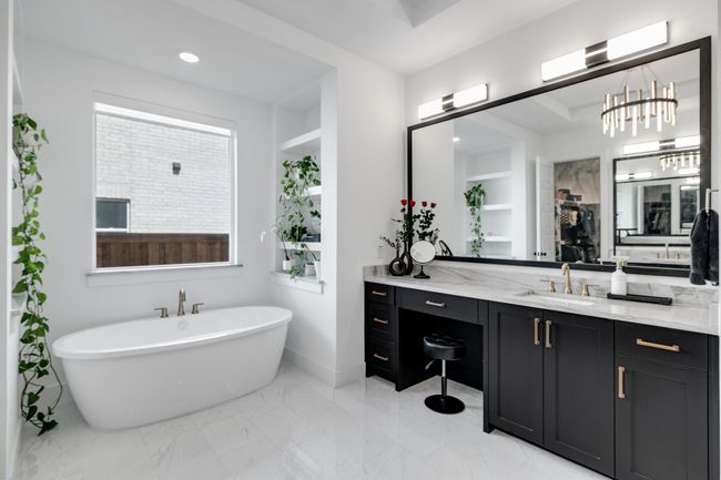 Bathroom featuring vanity, a soaking tub, marble finish flooring, recessed lighting, and baseboards | Image 24