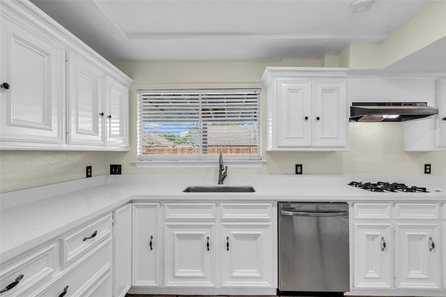 An additional view of the kitchen highlights its practical layout, designed for ease of movement and everyday use. | Image 10