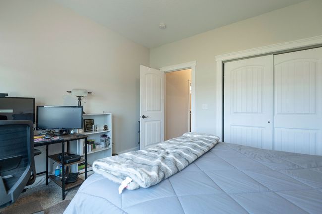 Bedroom featuring an office area and a closet | Image 20