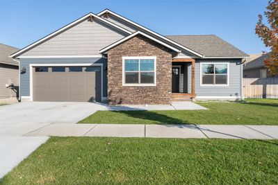 Craftsman-style home with a front yard and a garage | Image 1