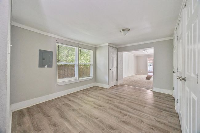 Spare room with electric panel, ornamental molding, plenty of natural light, and light wood-style floors | Image 12