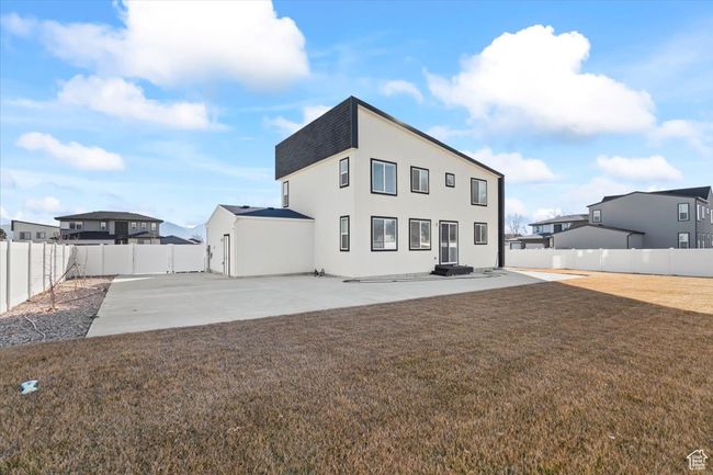 Rear view of house featuring a fenced backyard, a yard, a patio, stucco siding, and roof with shingles | Image 25
