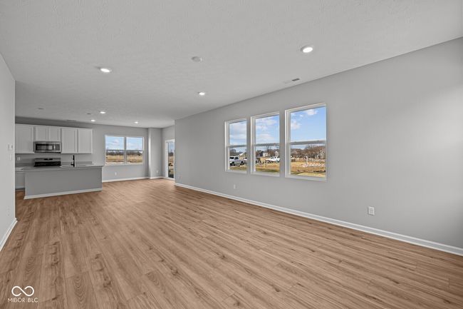 unfurnished living room featuring baseboards, recessed lighting, and light wood-type flooring | Image 10