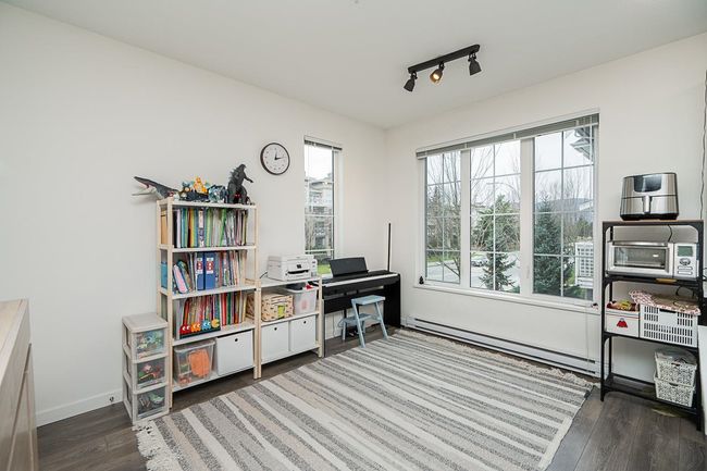 Office space featuring a toaster, baseboards, wood finished floors, a baseboard heating unit, and track lighting | Image 15