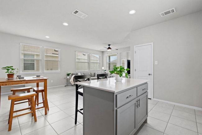 Kitchen with gray cabinetry, a center island, light tile patterned floors, a ceiling fan, and recessed lighting | Image 4
