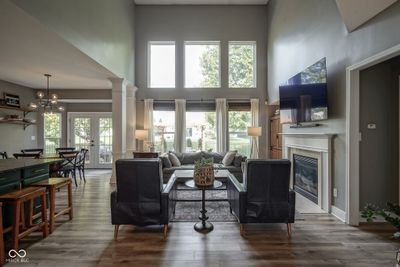 2 Story Great Room with floor to ceiling light, gas fireplace and open to the kitchen. | Image 3