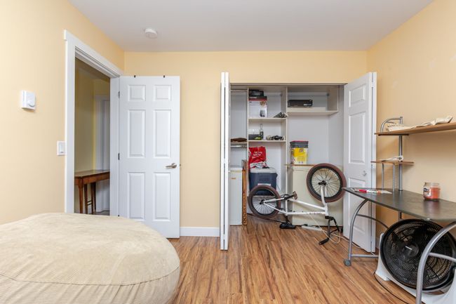 Bedroom with wood finished floors and a closet | Image 17