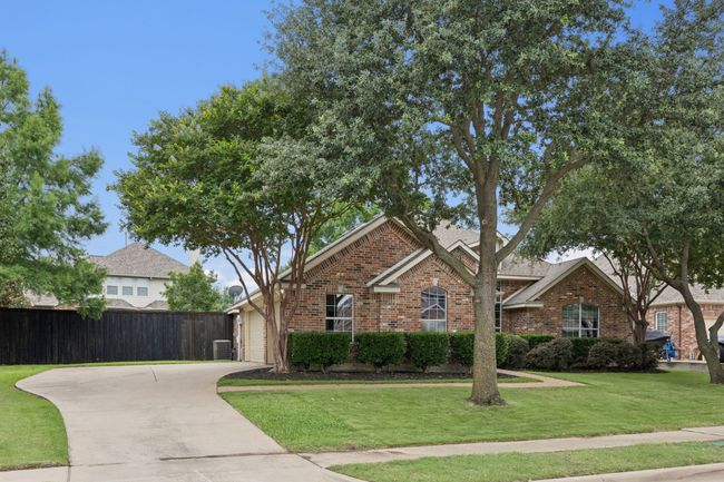 Set on a wide interior lot with mature trees and a curved drive, this brick home makes a warm and inviting first impression in a beautifully maintained and popular upscale neighborhood. | Image 34