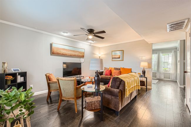 Bedroom featuring baseboards, crown molding, dark wood-style floors, and a ceiling fan | Image 4