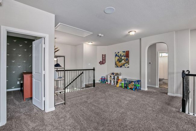 Playroom with attic access, carpet flooring, arched walkways, and baseboards | Image 18