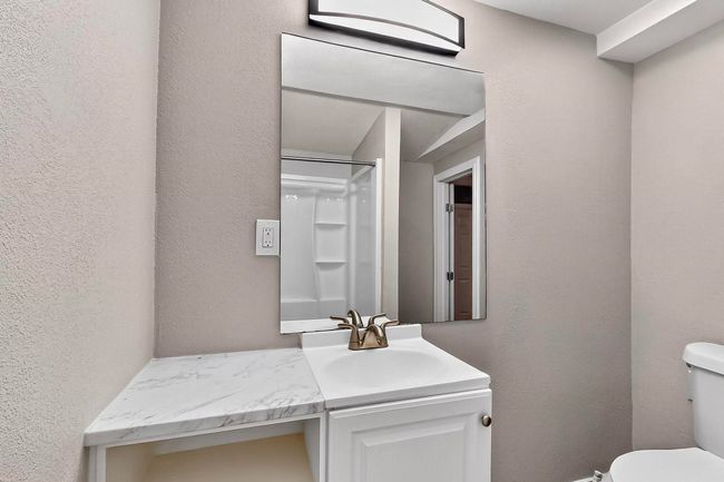 Bathroom with vanity and a textured wall | Image 19