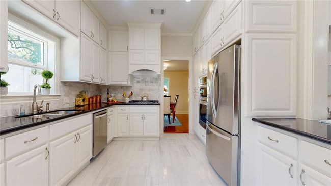 Full view of Kitchen with Gas SS Stove Top, Oven, Microwave, Refrigerator and Refrigerator Currently Destaged | Image 16