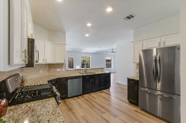Wonderful kitchen with tons of cabinet and counter space. The dishwasher, oven and microwave were recently installed. The refrigerator conveys! | Image 12