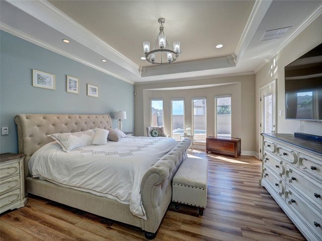 Stunning Primary Suite with soft decor colors and motorized blinds. | Image 15