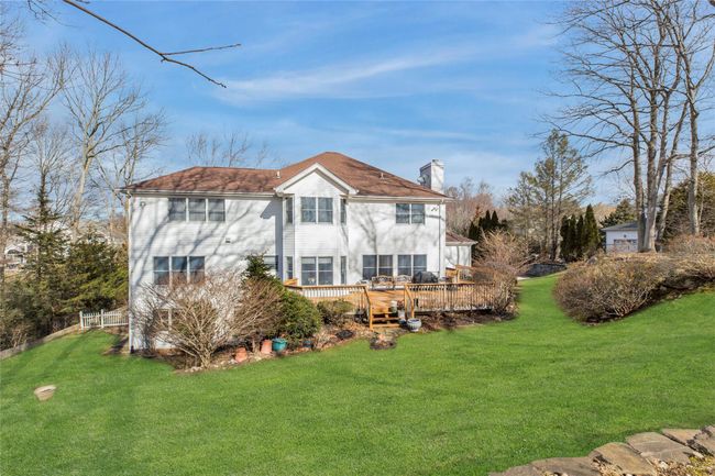 Back of house featuring a wooden deck and a yard | Image 25