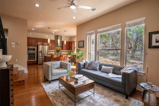 Living area featuring a ceiling fan, wood finished floors, and recessed lighting | Image 6