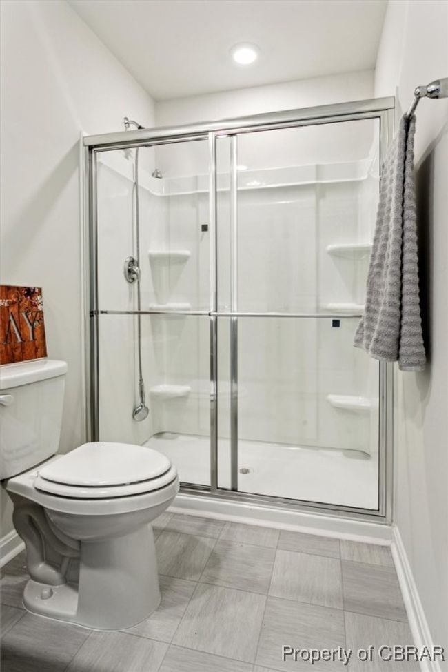 Full bathroom featuring baseboards, toilet, and a stall shower | Image 20