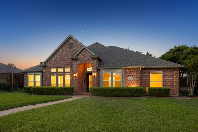 Traditional-style brick home at dusk | Image 31