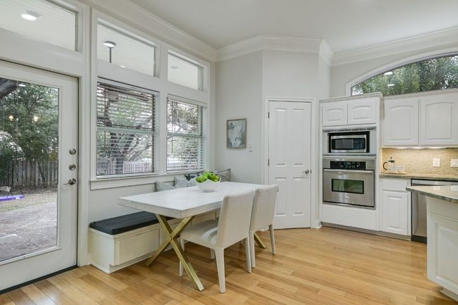 Eat-in kitchen with banquette seating and large pantry. | Image 12