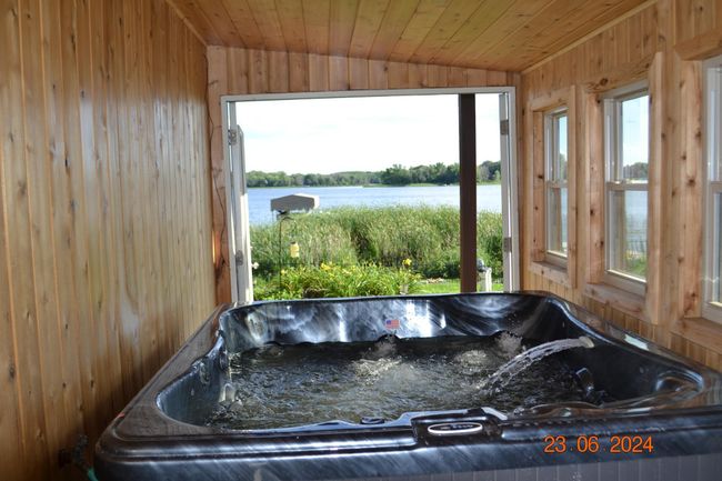 Relaxing hot tub overlooking serene Ham Lake | Image 60