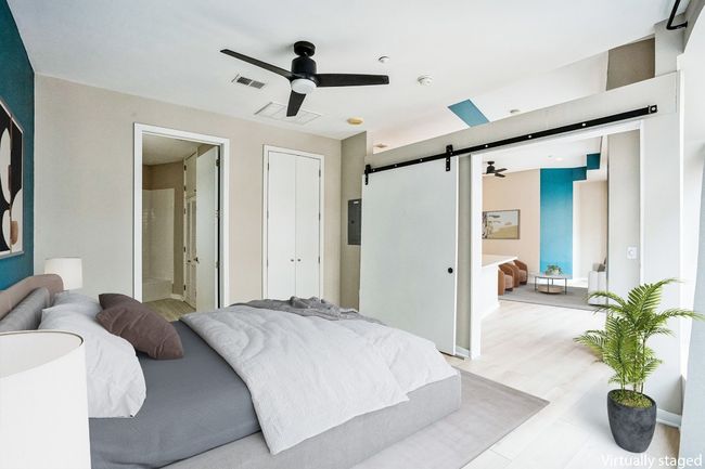 Bedroom with a barn door & ensuite bath | Image 8