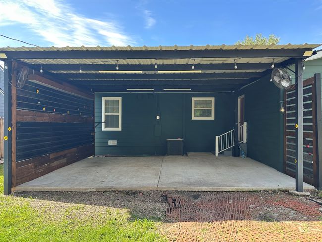 Rear view of house featuring cooling unit and an attached carport | Image 15