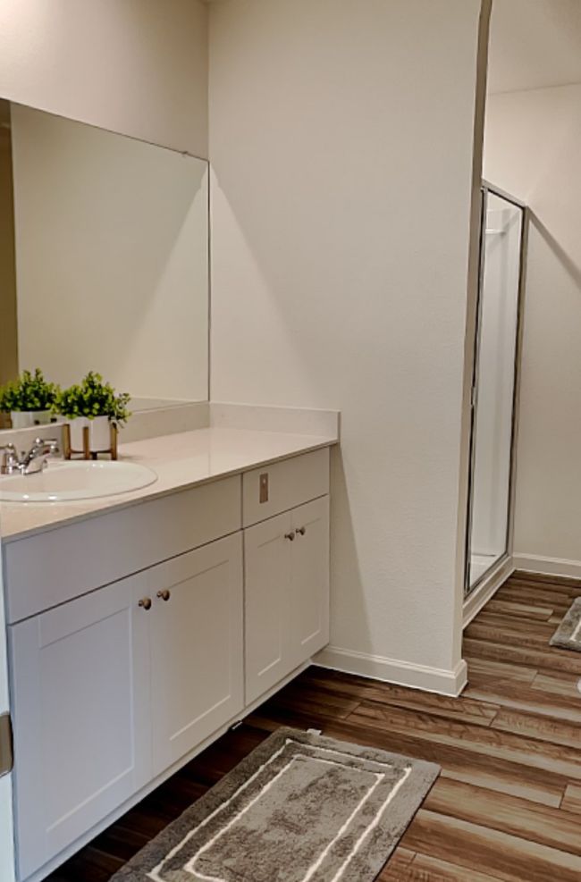 Full bathroom featuring vanity, a stall shower, and wood finished floors | Image 24