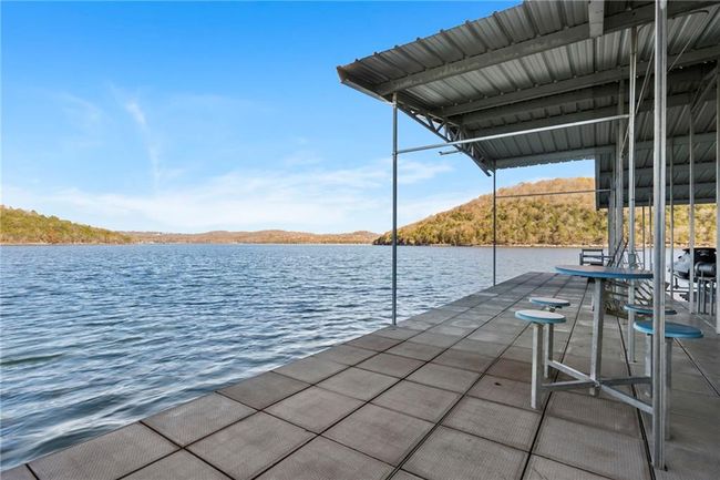 Dock area featuring a water and mountain view | Image 65
