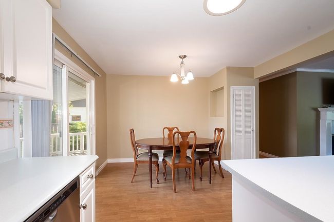 Dining space featuring a chandelier and light wood-style flooring | Image 11