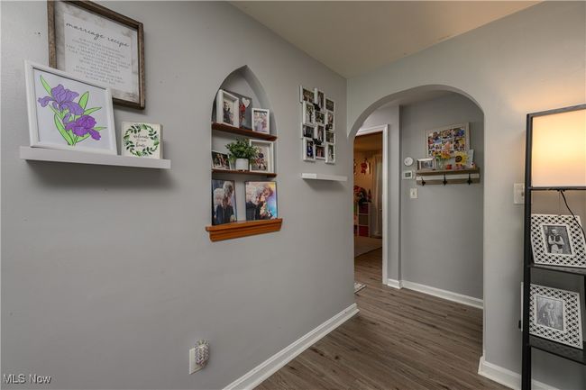 Corridor with wood finished floors and arched walkways | Image 9