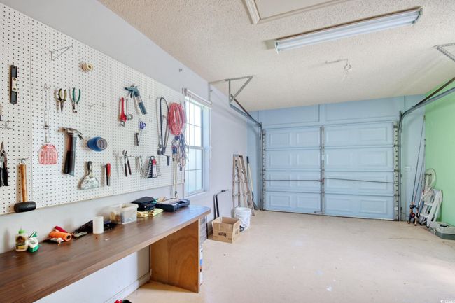 Garage featuring a workshop area | Image 33